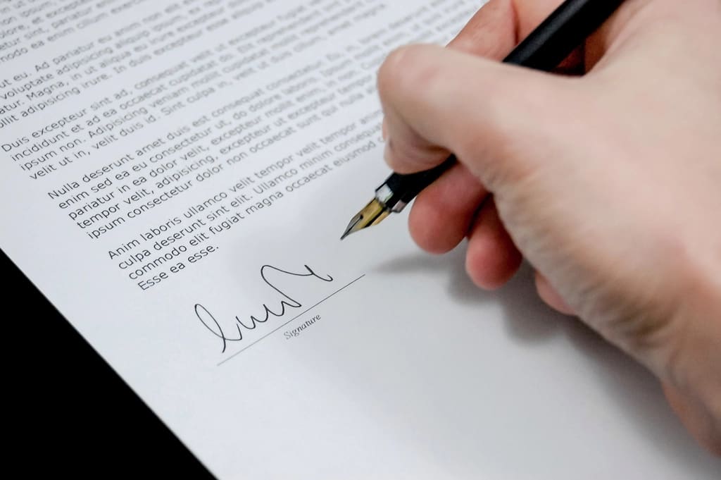 Mano firmando un documento